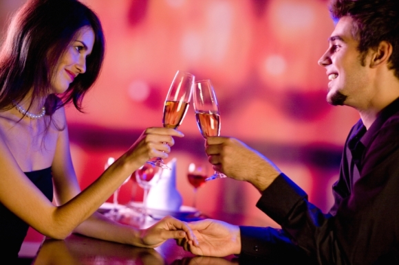 Amorous couple on romantic date or celebrating together at restaurant
